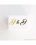 a white double ring box with two initials on the lid